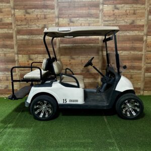 White golf cart parked indoors on turf